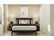 Bright bedroom with bedside lamps, a comfortable bed with stylish pillows, and a window offering natural light at 11784 Brae Way, Dade City, FL 33525