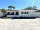 Charming one-story home with a white brick facade and well-lit front at 121 175Th E Ave, Redington Shores, FL 33708