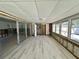Bright sunroom with light hardwood floors and multiple windows at 121 175Th E Ave, Redington Shores, FL 33708