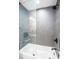 Sleek bathroom with a shower and tiled gray walls showcases a clean and modern design at 12335 Yellow Rose Cir, Riverview, FL 33569