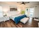 Bedroom featuring hardwood floors, a cozy bed, and sliding doors leading to a pool at 12335 Yellow Rose Cir, Riverview, FL 33569