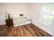 Bright bedroom features a white daybed and hardwood floors, creating a cozy and inviting space at 12335 Yellow Rose Cir, Riverview, FL 33569