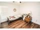 Bright bedroom with hardwood floors, natural light, and simple, elegant decor at 12335 Yellow Rose Cir, Riverview, FL 33569