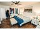 Bedroom with hardwood floors, art, and large bed offers a peaceful retreat at 12335 Yellow Rose Cir, Riverview, FL 33569