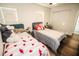 Bright bedroom with two beds, white walls, wood floors, and natural light from two windows at 12335 Yellow Rose Cir, Riverview, FL 33569