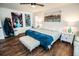 Bedroom featuring hardwood floors, large art, and comfortable bed for a stylish and cozy living space at 12335 Yellow Rose Cir, Riverview, FL 33569