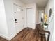 Bright foyer featuring hardwood floors, fresh white paint and modern decor at 12335 Yellow Rose Cir, Riverview, FL 33569