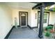 Welcoming front porch with modern tile flooring, accent plants, and stylish home number at 12335 Yellow Rose Cir, Riverview, FL 33569