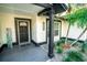 Welcoming front porch with modern tile flooring, accent plants, and stylish home number at 12335 Yellow Rose Cir, Riverview, FL 33569