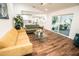 Spacious living room flowing into the kitchen with wood floors and an outdoor patio visible at 12335 Yellow Rose Cir, Riverview, FL 33569