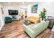 Bright and airy living room featuring wood floors, comfortable seating, and stylish decor at 12335 Yellow Rose Cir, Riverview, FL 33569