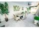 Covered patio with dining set, offering a view of the lush backyard and well-maintained landscaping at 12335 Yellow Rose Cir, Riverview, FL 33569