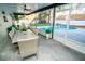 Enclosed patio with dining table and chairs overlooking the sparkling pool and landscaped backyard at 12335 Yellow Rose Cir, Riverview, FL 33569