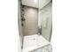 Modern shower featuring gray tiling, glass enclosure, and unique hexagon-patterned flooring at 12335 Yellow Rose Cir, Riverview, FL 33569