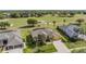 Stunning aerial view of home, showcasing landscaping, and adjacent golf course at 13514 Thoroughbred Dr, Dade City, FL 33525
