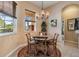 Charming breakfast nook with a round table and natural light from the window at 13514 Thoroughbred Dr, Dade City, FL 33525