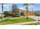 Charming single-story home with manicured lawn, mature trees, and a three-car garage at 13514 Thoroughbred Dr, Dade City, FL 33525