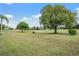 Scenic view of the golf course with well-maintained greens and mature trees at 13514 Thoroughbred Dr, Dade City, FL 33525