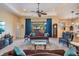Comfortable living room with tray ceilings, tile floors, and views of the backyard at 13514 Thoroughbred Dr, Dade City, FL 33525