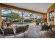 Relaxing screened-in pool area with outdoor seating and picturesque golf course views at 13514 Thoroughbred Dr, Dade City, FL 33525