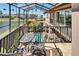 Screened balcony with outdoor seating overlooking a pool and picturesque lake at 1408 Alhambra Dr, Apollo Beach, FL 33572