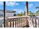 Balcony overlooking lush landscaping, a lawn, and a glimpse of the lake in the background at 1408 Alhambra Dr, Apollo Beach, FL 33572