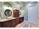 Bathroom with granite countertop vanities and decorative mirrors at 1408 Alhambra Dr, Apollo Beach, FL 33572