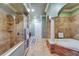 Elegant bathroom features a glass enclosed shower and soaking tub with decorative columns at 1408 Alhambra Dr, Apollo Beach, FL 33572