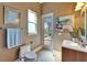 A peaceful half bathroom featuring modern fixtures, a vessel sink, and views of the outdoor greenery at 1408 Alhambra Dr, Apollo Beach, FL 33572