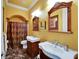 Elegant bathroom featuring dual vanities, marble floors, and a decorative shower curtain at 1408 Alhambra Dr, Apollo Beach, FL 33572