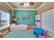Cozy bedroom with a playful decor, including a stuffed animal hammock and -sized furniture at 1408 Alhambra Dr, Apollo Beach, FL 33572
