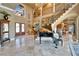 Stately foyer with grand staircase, piano, double entry doors, and large windows for natural light at 1408 Alhambra Dr, Apollo Beach, FL 33572