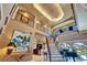 Open floor plan featuring a grand foyer with soaring ceilings, wrought iron staircase, and piano at 1408 Alhambra Dr, Apollo Beach, FL 33572