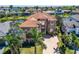 Stunning front exterior featuring a tile roof, manicured lawn, and mature landscaping at 1408 Alhambra Dr, Apollo Beach, FL 33572