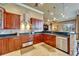 Gourmet kitchen featuring dark wood cabinets, granite countertops, and stainless steel appliances at 1408 Alhambra Dr, Apollo Beach, FL 33572