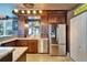 Modern kitchen featuring stainless steel appliances, custom wood cabinetry, and granite countertops at 1408 Alhambra Dr, Apollo Beach, FL 33572