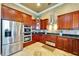 Modern kitchen features stainless appliances, dark wood cabinets, and granite countertops at 1408 Alhambra Dr, Apollo Beach, FL 33572