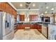 Gourmet kitchen featuring stainless steel appliances, dark wood cabinetry, and granite countertops at 1408 Alhambra Dr, Apollo Beach, FL 33572