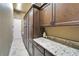 Laundry room featuring custom cabinets and granite countertops, offering both style and functionality at 1408 Alhambra Dr, Apollo Beach, FL 33572