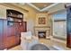 Cozy sitting area with a fireplace, built-in cabinets, and a comfortable armchair at 1408 Alhambra Dr, Apollo Beach, FL 33572