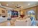 Comfortable living room with a fireplace, built-in shelving, and large windows at 1408 Alhambra Dr, Apollo Beach, FL 33572