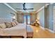 Well-lit main bedroom with a king size bed, bench, and balcony access at 1408 Alhambra Dr, Apollo Beach, FL 33572