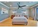Bright main bedroom featuring hardwood floors, a ceiling fan, and neutral tones at 1408 Alhambra Dr, Apollo Beach, FL 33572
