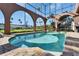 Indoor pool with arched windows offering views of the backyard and landscaping at 1408 Alhambra Dr, Apollo Beach, FL 33572