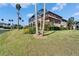 Exterior of home with screened in pool, large yard and pond view at 1408 Alhambra Dr, Apollo Beach, FL 33572