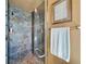 Modern shower featuring decorative tile, glass enclosure and modern fixtures at 1408 Alhambra Dr, Apollo Beach, FL 33572