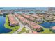 Community aerial view of waterfront homes with red tile roofs and lush landscaping on a sunny day at 16 Franklin S Ct # A, St Petersburg, FL 33711