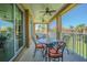 A screened balcony with a dining set provides a tranquil outdoor living space at 16 Franklin S Ct # A, St Petersburg, FL 33711