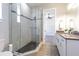 Bathroom showcasing a walk-in shower with mosaic tile and granite vanity at 16 Franklin S Ct # A, St Petersburg, FL 33711