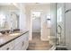 Bathroom featuring a vanity with a granite top, glass shower, and wood look flooring at 16 Franklin S Ct # A, St Petersburg, FL 33711